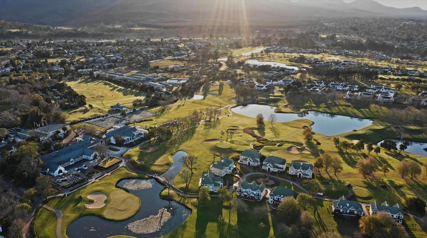Fancourt clubhouse and 18th green at golden hour