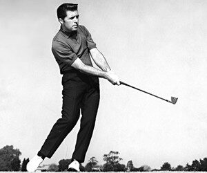 Portrait of Gary Player on course in trademark black, club in hand