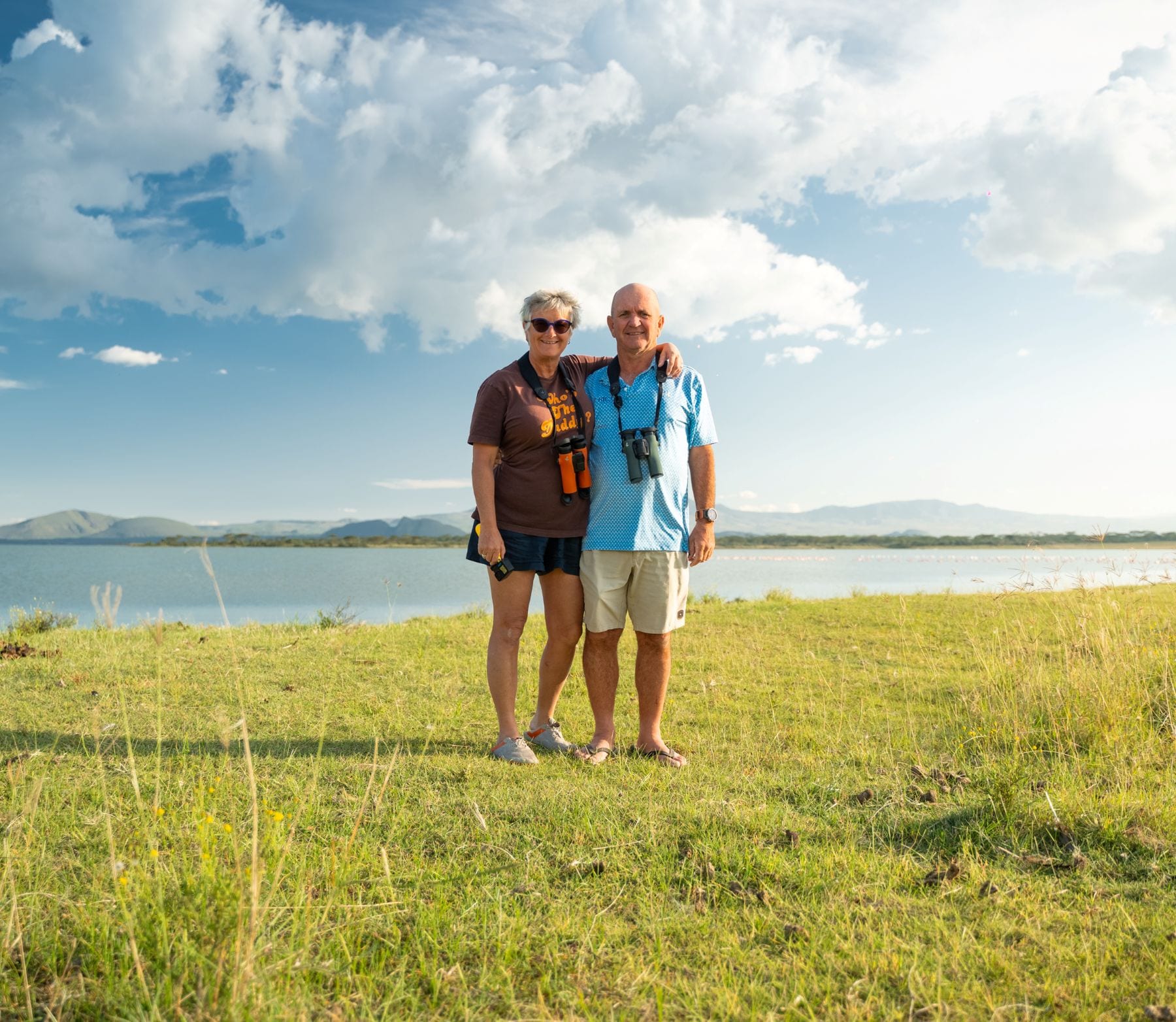 Couple planning a custom African golf safari itinerary on a lodge deck