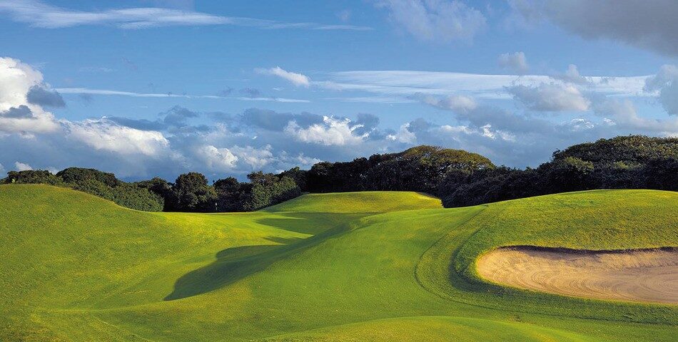 Durban Country Club's rolling dune fairways with the Indian Ocean beyond