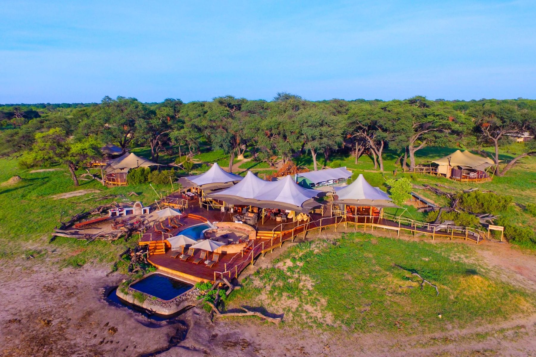 Somalisa Camp tent and elephant at the pool, Hwange Zimbabwe